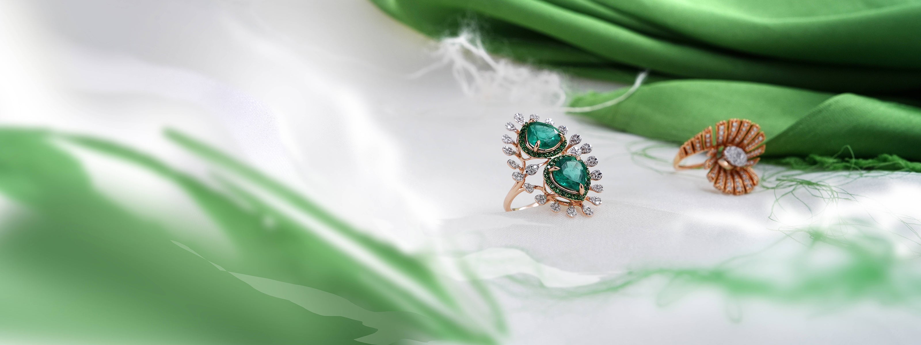 Pair of earrings on a green fabric background